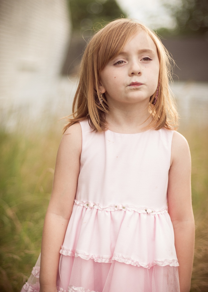 Girl wearing pink dress making silly face