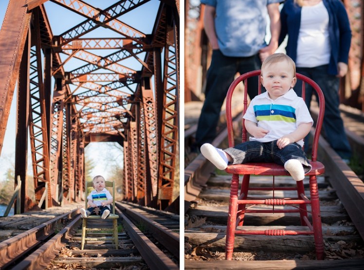 Boy sitting on vintage chair on rustic train tracks