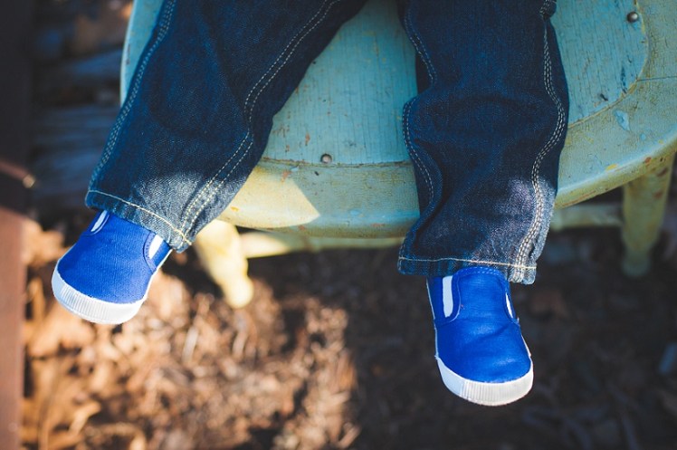 Boy's blue shoes on vintage chair