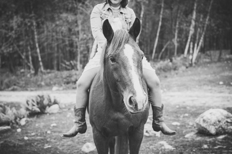 Girl riding a horse black and white