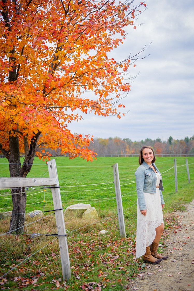 Cowgirl senior portrait in front of beautiful foliage