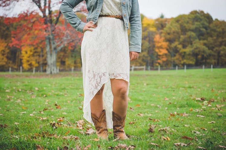 Cowgirl wearing boots standing in field hand on hip