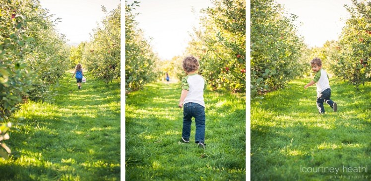 Brother and sister running through apple orchard