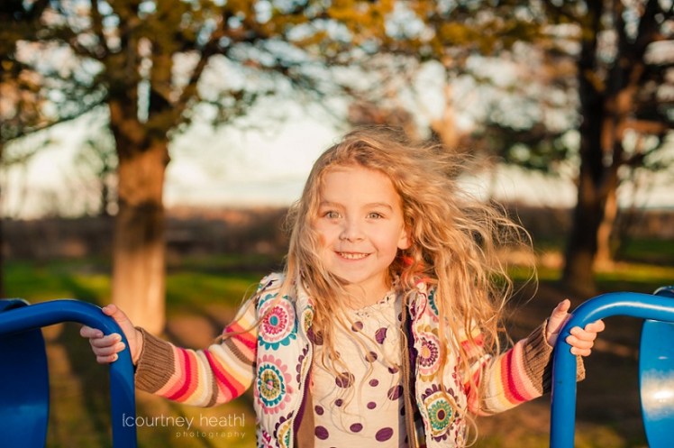 Beautiful girl with long curly hair during golden hour
