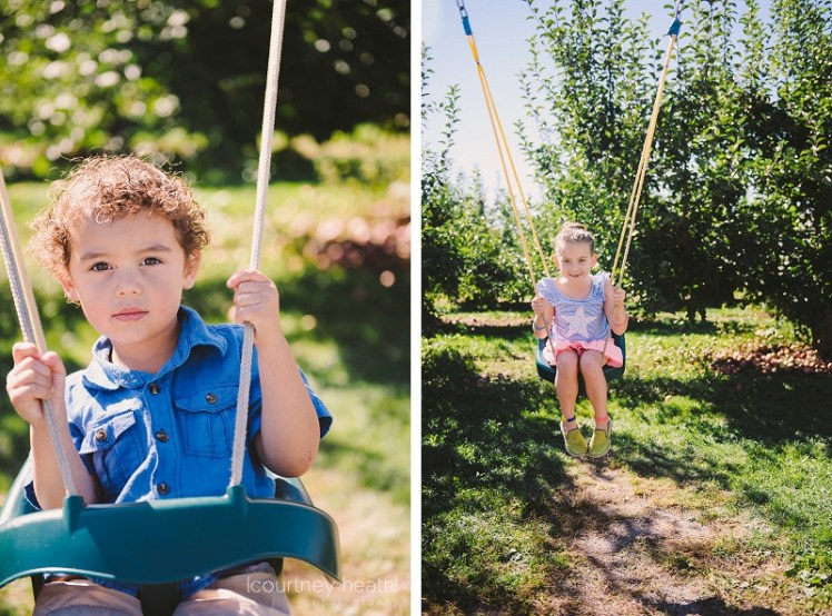 Brother and sister swinging on swings
