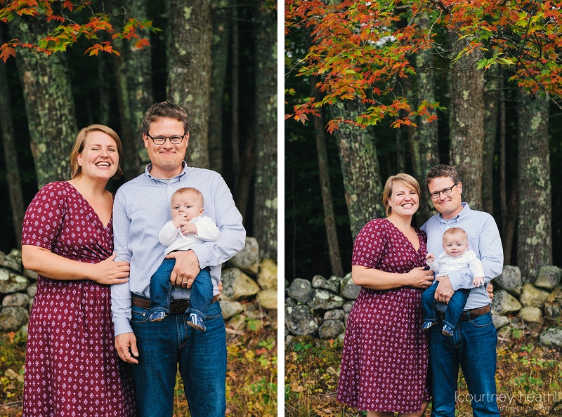 Family in front of stone wall and fall foliage