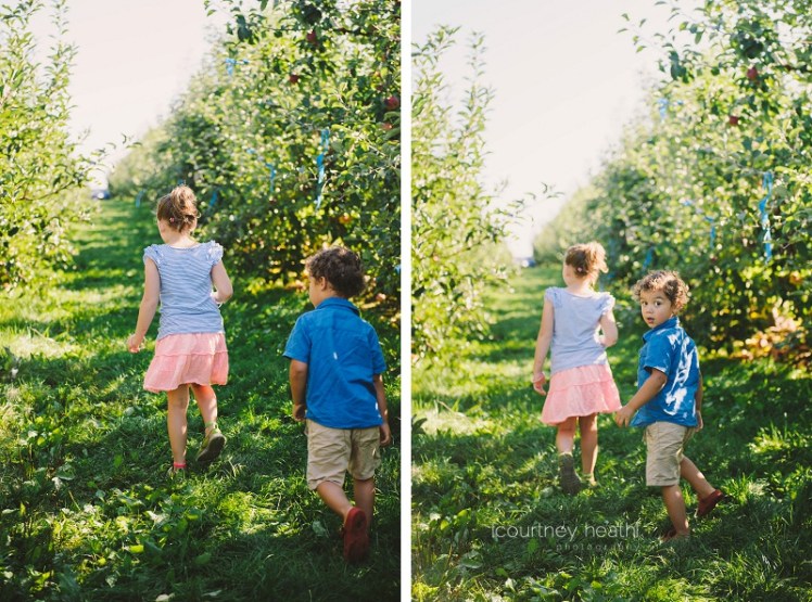 Brother and sister walking in an apple orchard