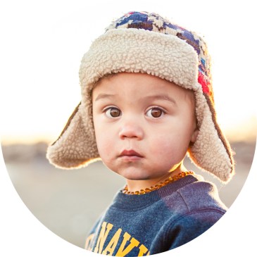 Brown eyed boy wearing pilot hat